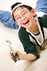 Image showing Winning boy with his medal and trophy