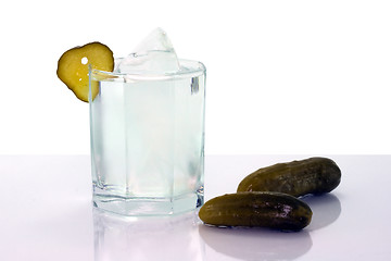 Image showing Vodka with ice in glass and salt cucumbers