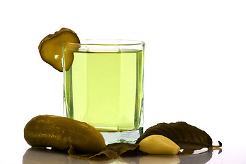 Image showing Cucumber brine in the glass and salt vegetables