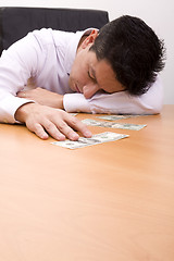 Image showing Sleeping over the money