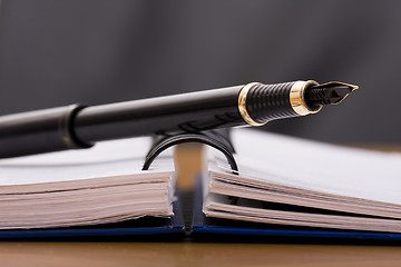 Image showing pen over a notepad