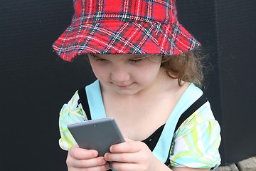 Image showing Little girl with calculator