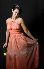 Image showing shapely pretty young woman smiling pretty dress with rose