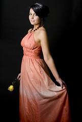 Image showing shapely pretty young woman smiling pretty dress with rose