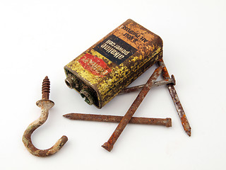 Image showing Rusty battery and nails