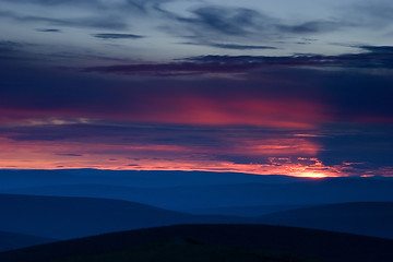 Image showing Bloody Sunset over hill terrain