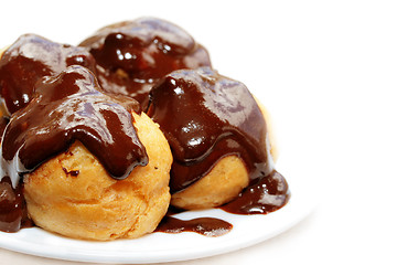 Image showing Fresh profiteroles with hot chocolate sauce.