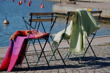 Image showing two chairs from cafe on the city embankment