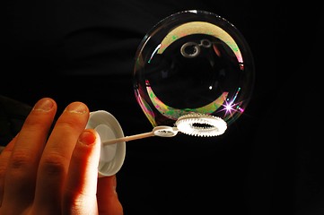 Image showing child's hand and soap bubble