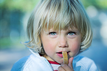 Image showing Little girl with bread