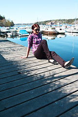 Image showing Attractive young woman posing near the harbor