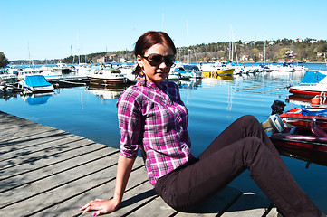 Image showing Attractive young woman posing near the harbor