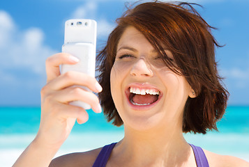 Image showing happy woman with phone on the beach