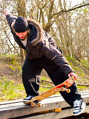 Image showing Urban Lifestyle -Young teenage skatboarder doing tricks 