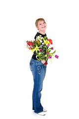 Image showing Happy smiling young girl presenting flowers 