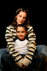 Image showing aunt and nephews over black background