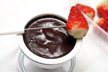 Image showing strawberry in chocolate fondue