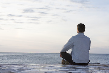 Image showing Man meditating at the sea