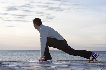 Image showing Man doing exercises at the sea