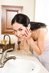 Image showing Woman washing face