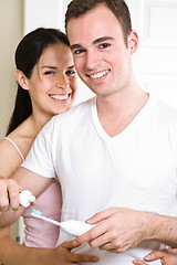 Image showing Couple brushing teeth in the bathroom