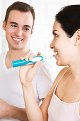 Image showing Couple brushing teeth in the bathroom