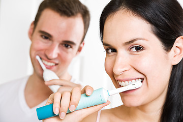 Image showing Couple brushing teeth in the bathroom