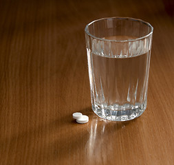 Image showing glass and pills