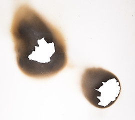 Image showing two burnt holes