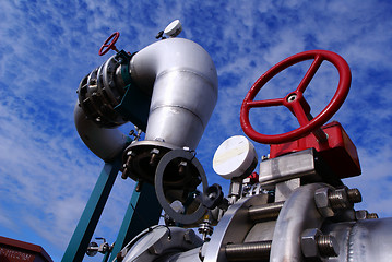 Image showing industrial pipelines on pipe-bridge against blue sky   