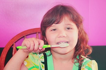 Image showing Young girl brushing her teeth