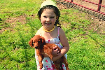 Image showing Little girl with puppy