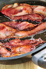 Image showing Bacon frying in a pan