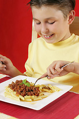 Image showing Child eating pasta
