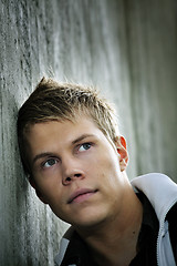 Image showing Man leaning against a wall