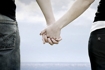 Image showing A couple holds hands i