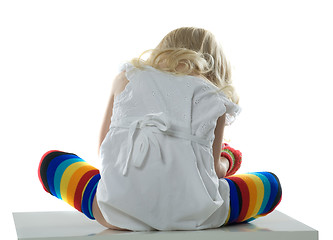 Image showing little girl sits back on white chair