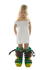 Image showing little girl in white dress and big ski boots