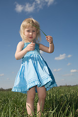 Image showing little girl with grass in hands