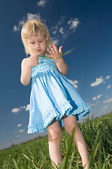 Image showing little girl with grass in hands