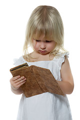 Image showing Little girl looks in purse