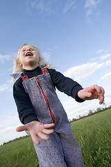 Image showing happy little girl on green meadow