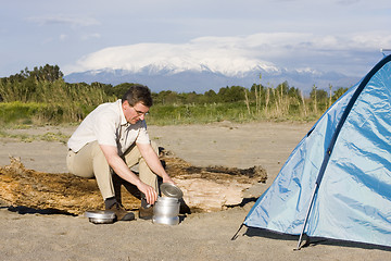 Image showing Man beside his tent