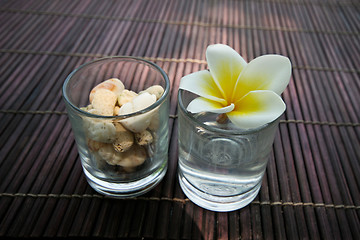 Image showing Tropical frangipani flower and stone decoration.