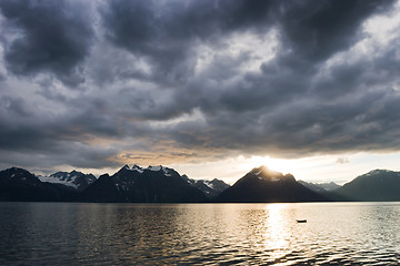 Image showing sunset at lake with dark clouds