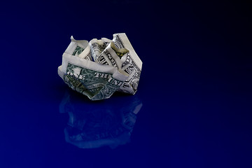 Image showing Crumpled dollar isolated on blue