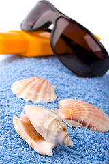 Image showing towel, shells, sunglasses and lotion