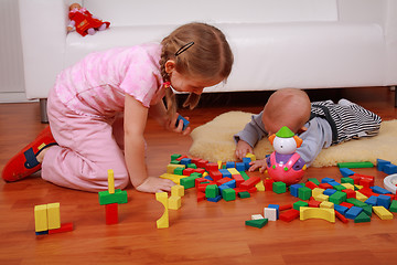 Image showing Adorable kids playing with blocks