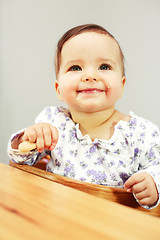 Image showing Small cute baby eating