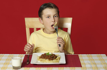 Image showing Child eating pasta